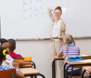 Teacher giving a lesson in classroom at the elementary school Teacher giving a lesson in classroom at the elementary school